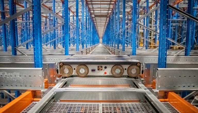 Warehouse automation system with metal shelves and robots.