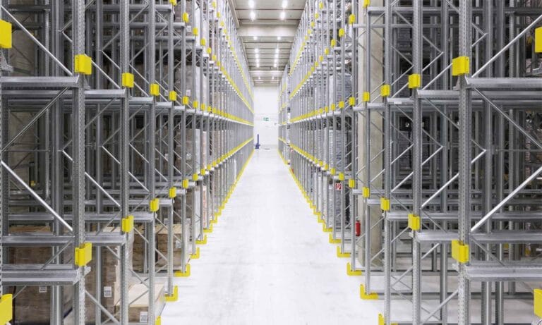 Empty industrial warehouse shelves with yellow supports