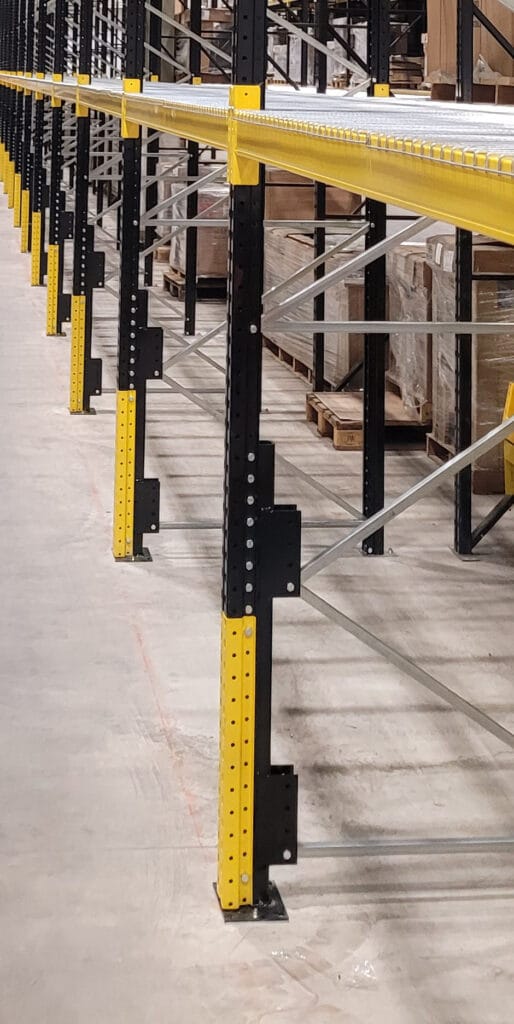 Warehouse shelving with yellow safety guards