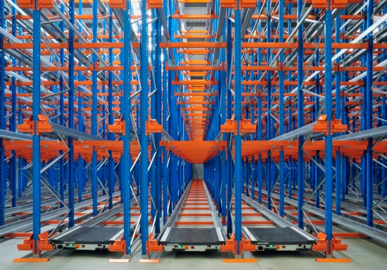 Advanced warehouse racking system with blue and orange shelves.