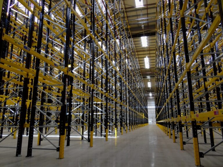 Empty warehouse with tall shelving units.